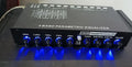 Black car audio EQ tuning amplifier with front panel controls for frequency and volume adjustment