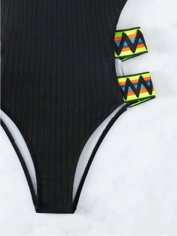 Solid colour women's one-piece polyester swimsuit on a model, available in black and orange.