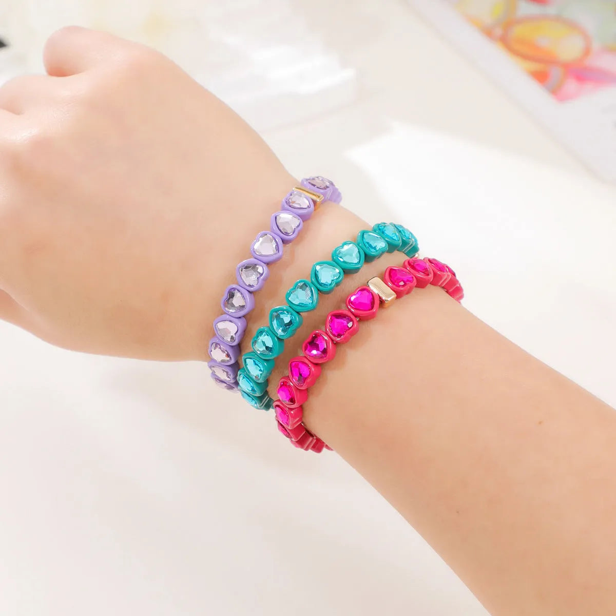 Rainbow enamel alloy heart stretch bracelet in TCSL003 colour variant on a white background