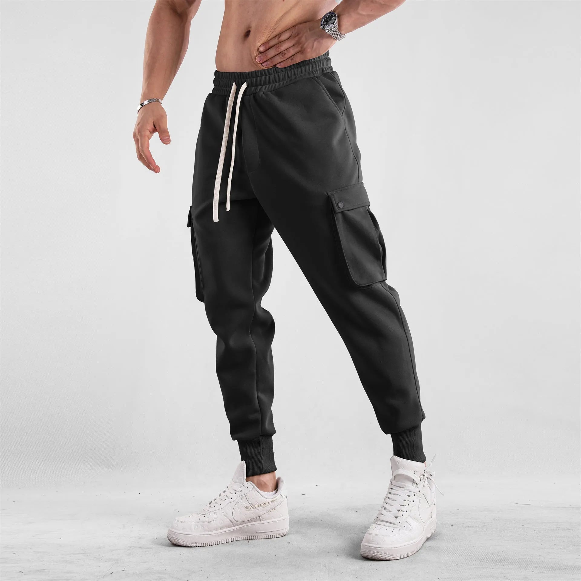 Men's loose cotton trousers with multiple pockets and adjustable ankle ties in solid colour options