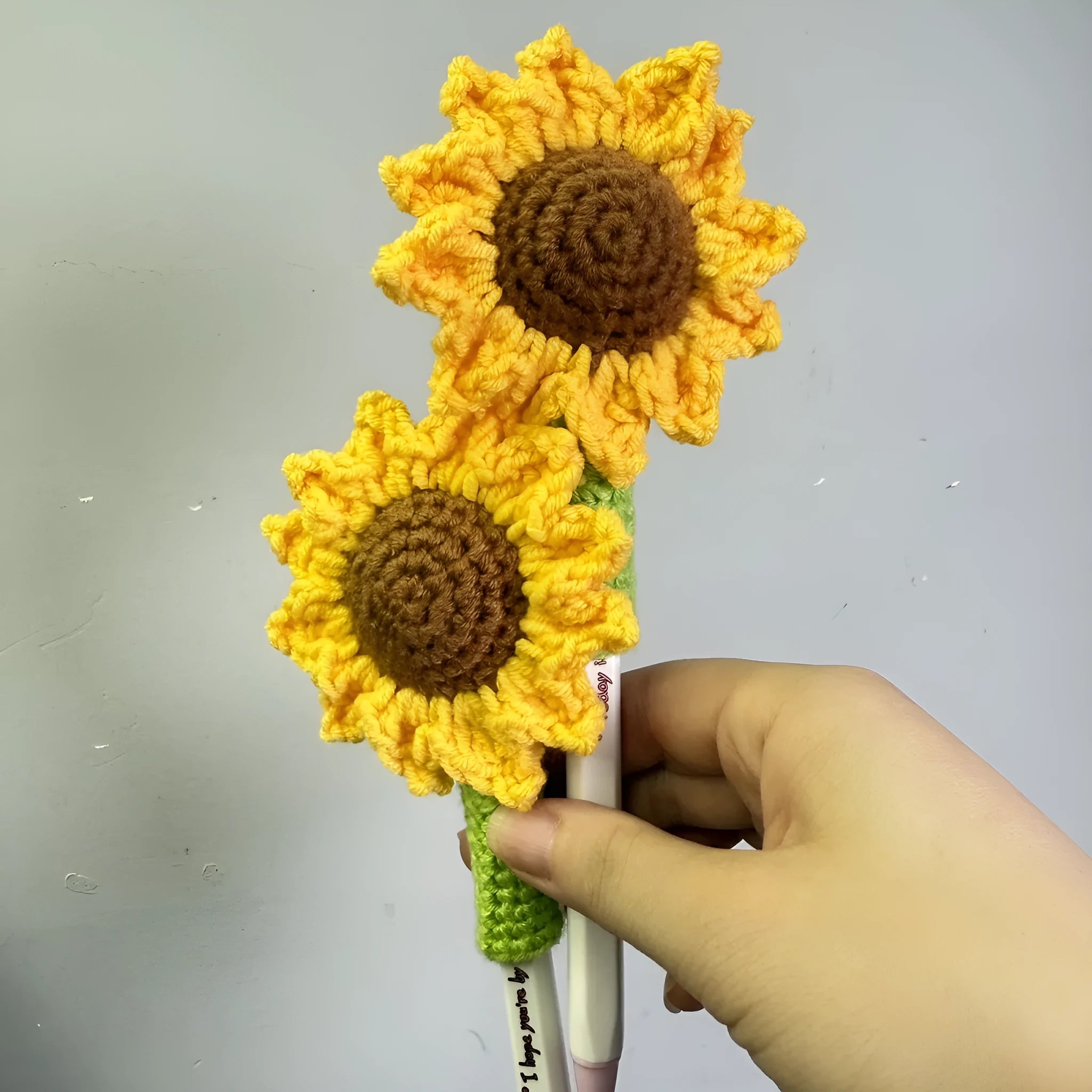 Hand-woven sunflower pen cover in fabric with sunflower design, available as desk storage for pens and pencils