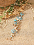 Alloy starfish bracelet with blue coral rhinestone boat anchor charm on a wrist.