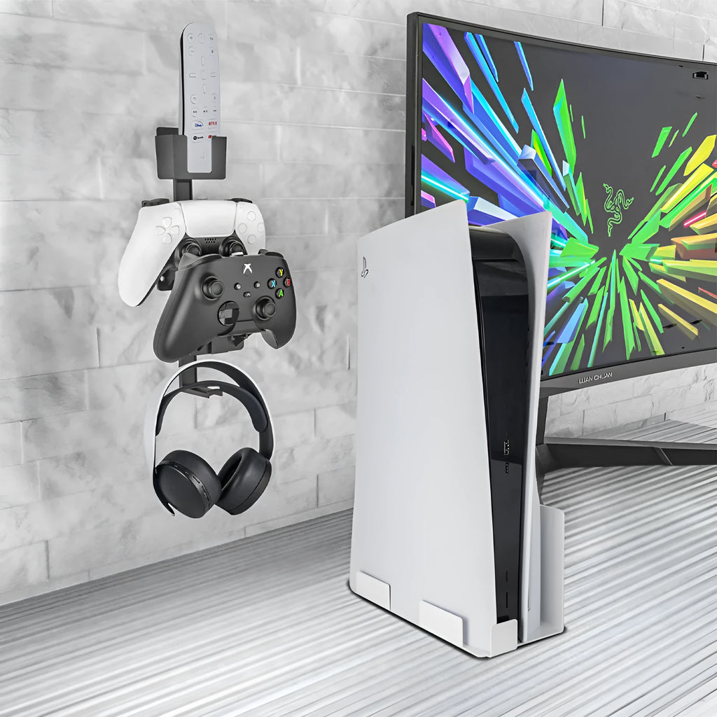 White ABS plastic wall hook holding a black game controller and TV remote.