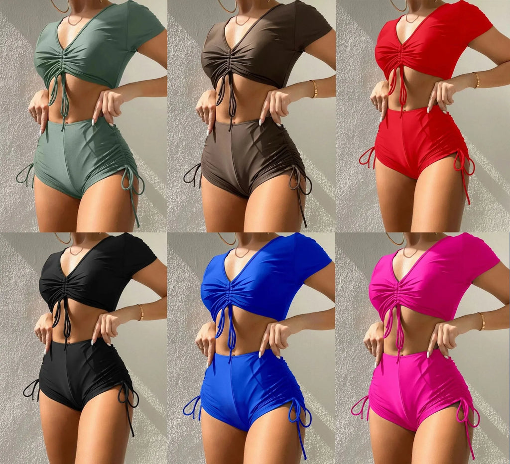 Women's dark green lace-up bow swimsuit top with matching shorts laid flat.