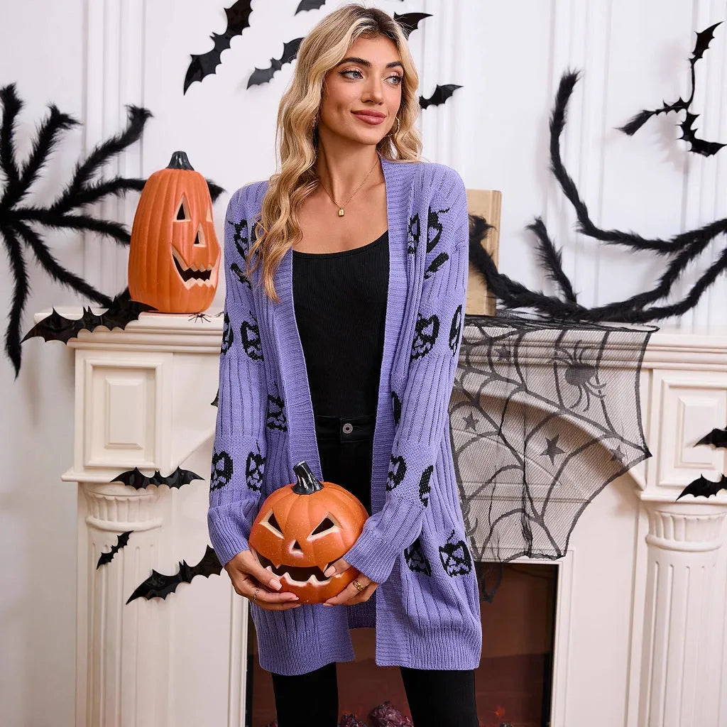 Women's black Halloween cardigan with jacquard-knitted orange pumpkin head pattern, shown as a straight-cut medium-length coat.