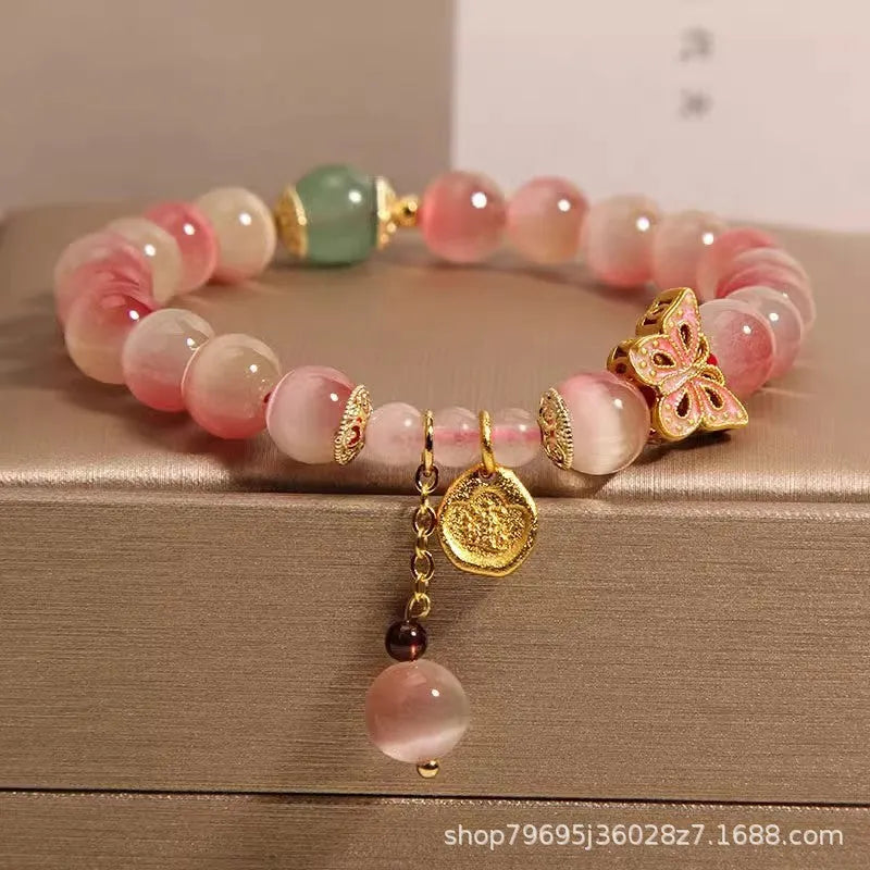 Pink opal butterfly women's bracelet with electroplated finish, Chinese style, on display