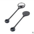Close-up of a black metal bicycle rearview mirror with hose adjustment mechanism and reflector on a handlebar