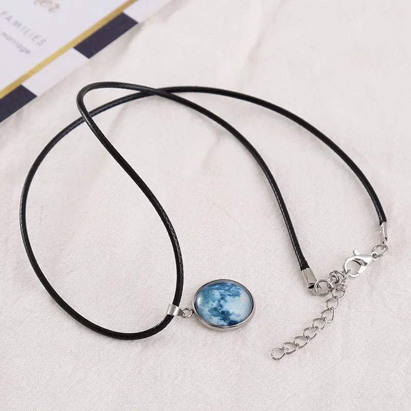 Luminous alloy pendant necklace with Christmas moon, night sky, and constellation design on a glass centrepiece.