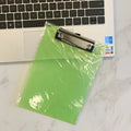 Transparent plastic A4 plate holder with metal clip and integrated writing board surface, shown in blue.