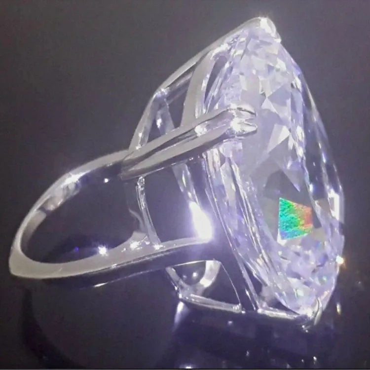 Simple women's ring with an inlaid square diamond design in a white gold colour.