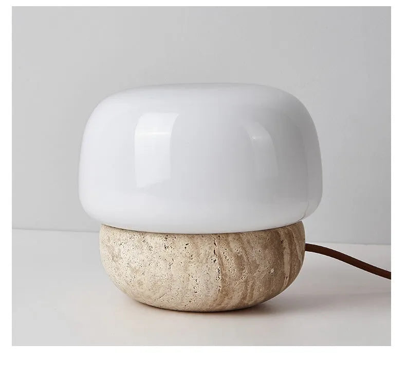 Cream-coloured retro style bedside lamp on a table.