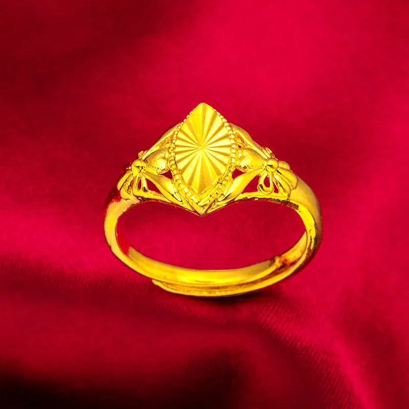 Gold coloured open diamond flower shape ring with geometric textured details on a brass base.