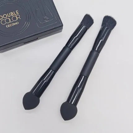 Double-headed black makeup brush with angled sponge and concealer brush on wooden handle