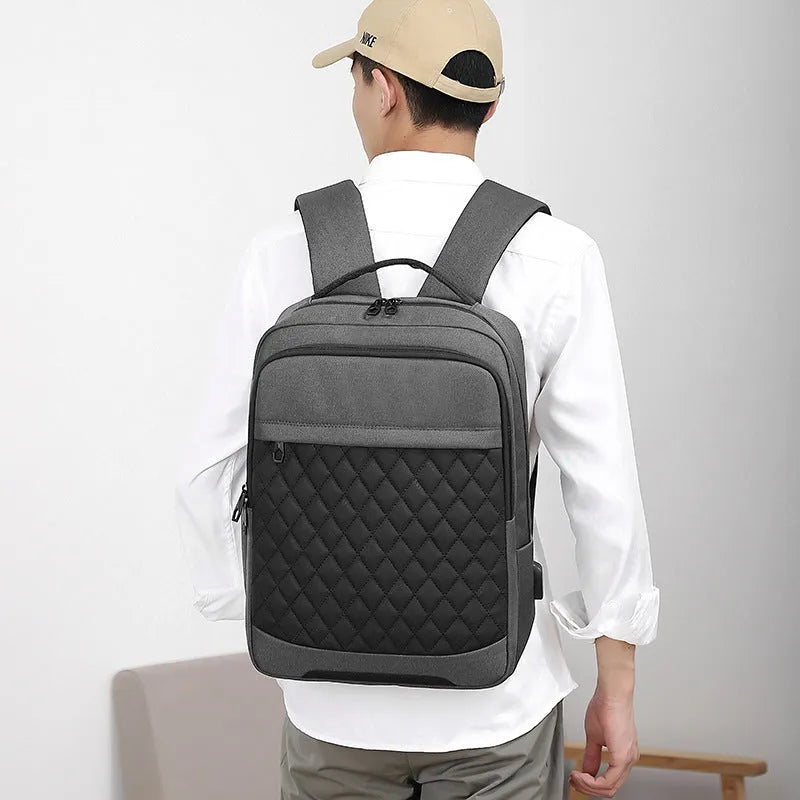 Men's leisure travel backpack in solid black Oxford cloth with curved shoulder straps and diamond mesh detailing