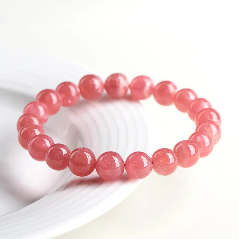 Women's red rhodochrosite crystal bracelet with geometric beads and a longevity lock clasp.