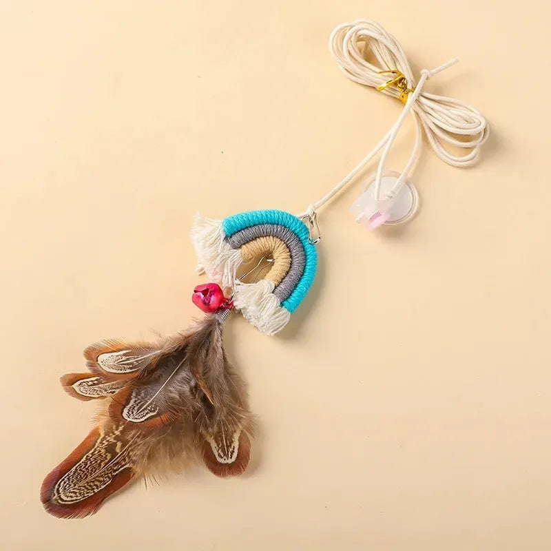 Blue feather rope cat toy hanging from door on elastic cord with adhesive clamp