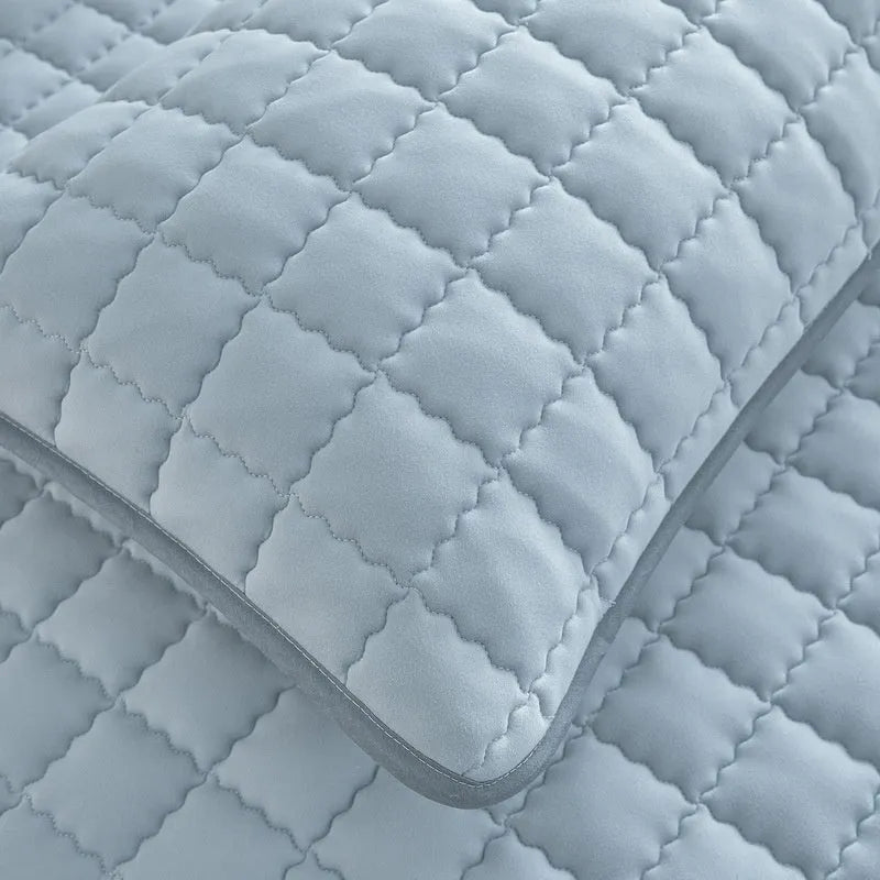 Blue quilted waterproof fitted sheet with elasticated corner on a mattress