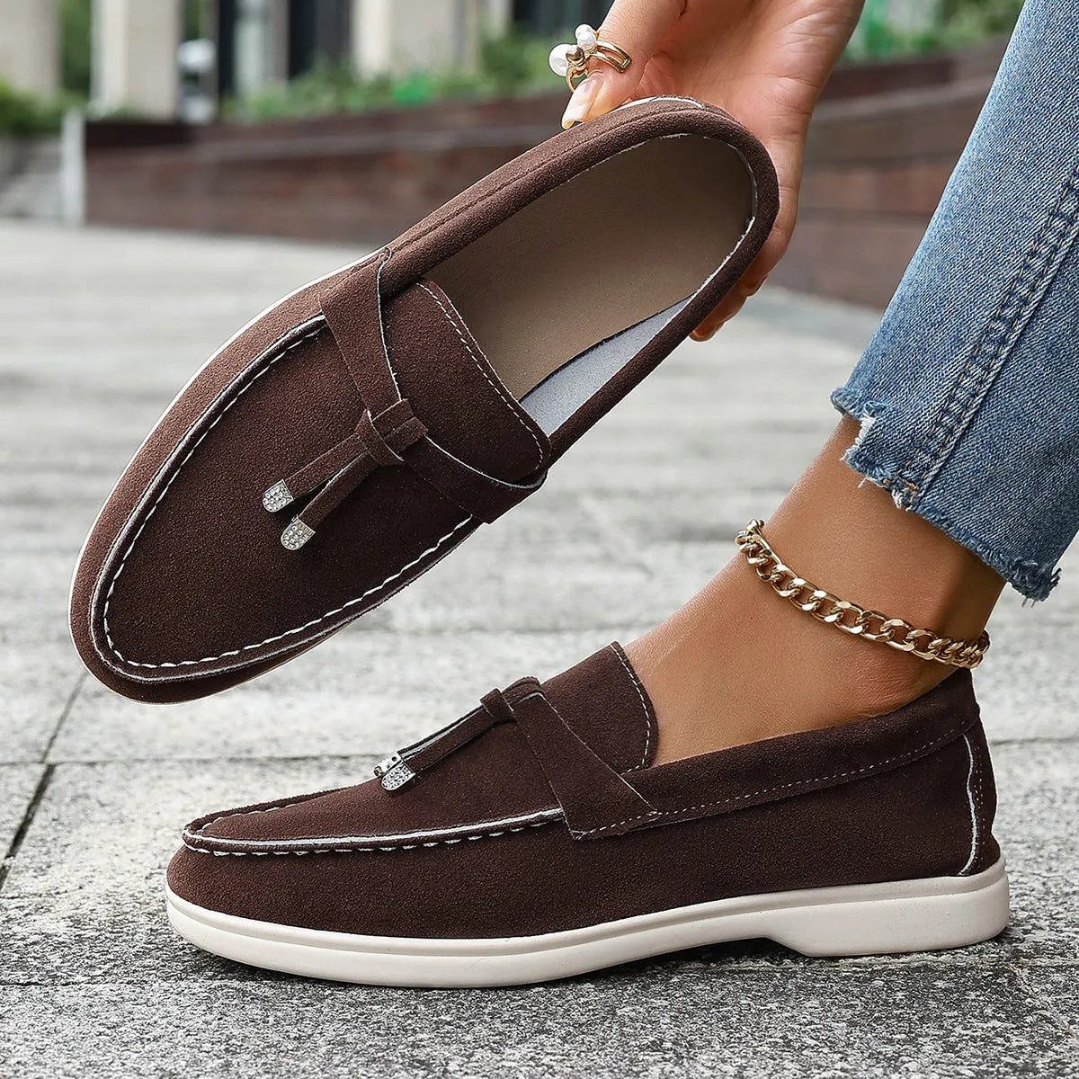 A pair of slip-on canvas loafers with a platform heel and round toe in a solid colour.