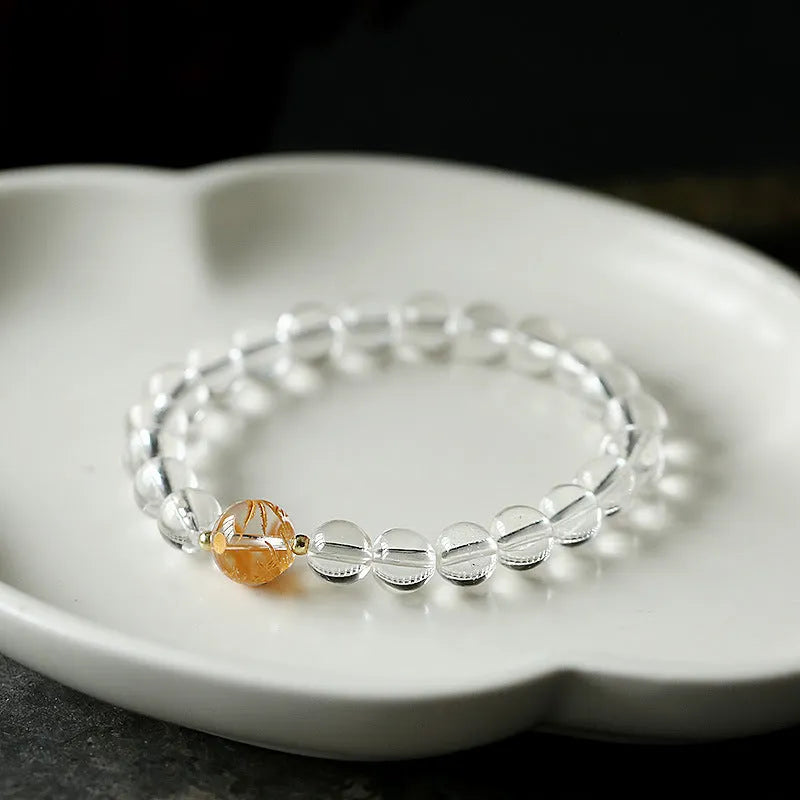 Unisex obsidian black agate and white crystal beaded bracelet on a neutral background, 10mm and 8mm beads