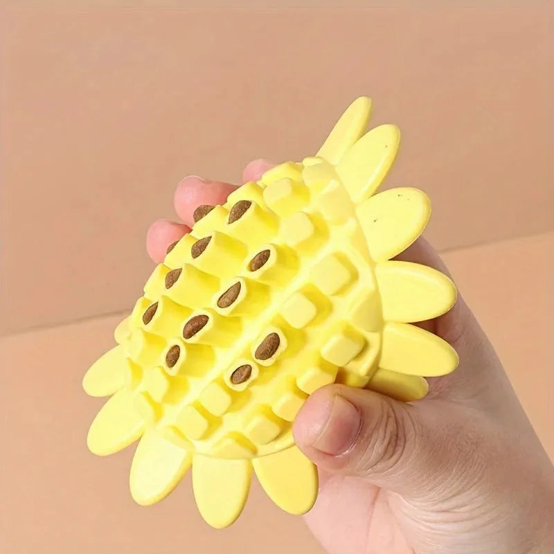 Yellow rubber sunflower dog chew toy on a surface, non toxic and BPA free for puppy teething