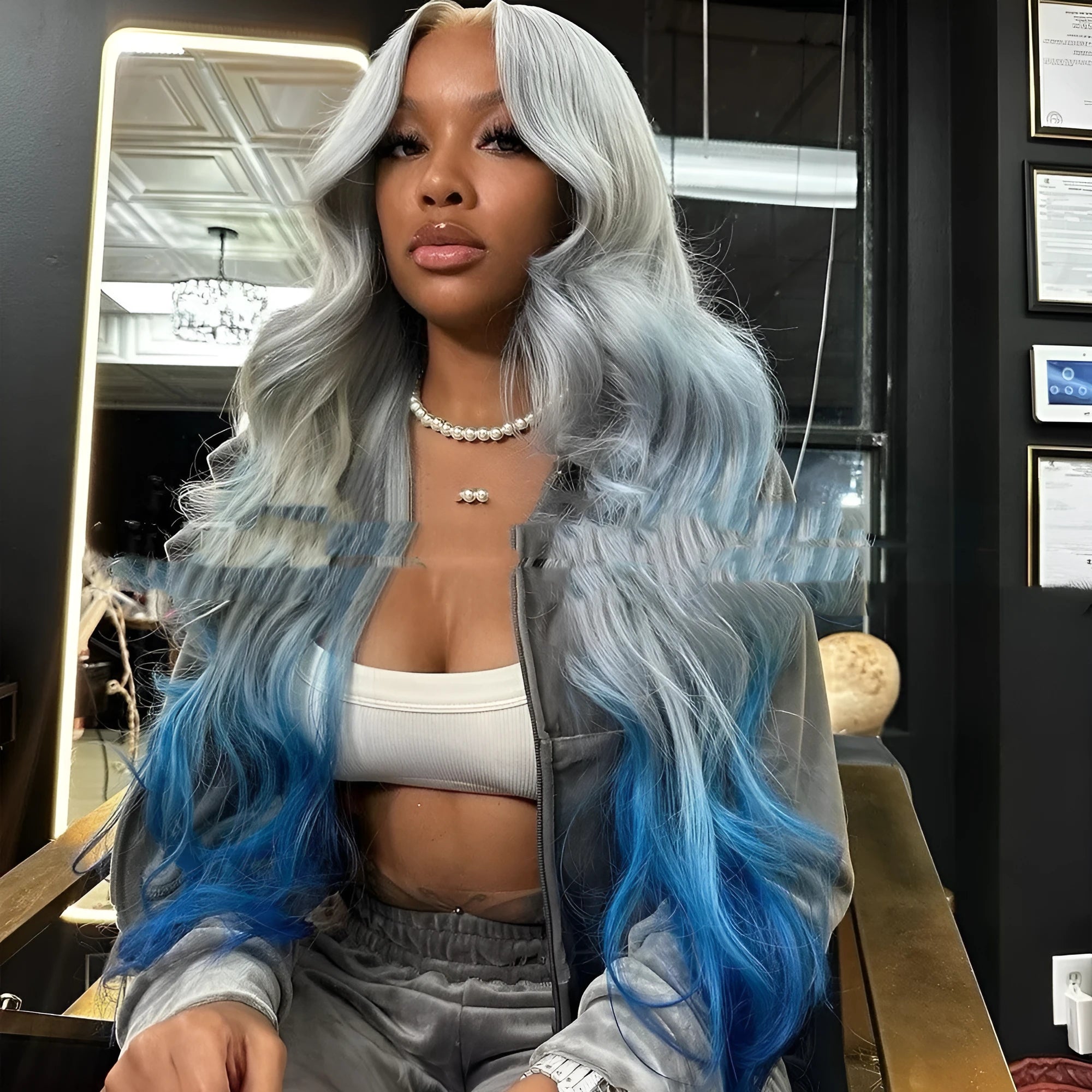 Grey to blue gradient human hair lace front wig with 4x4 frontal on a wig stand.