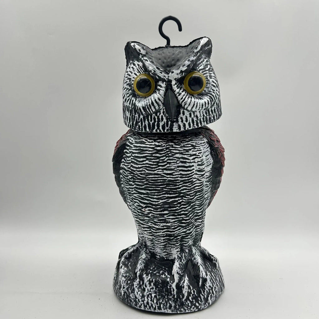 Artificial owl garden ornament with shaking head for bird deterrent on patio