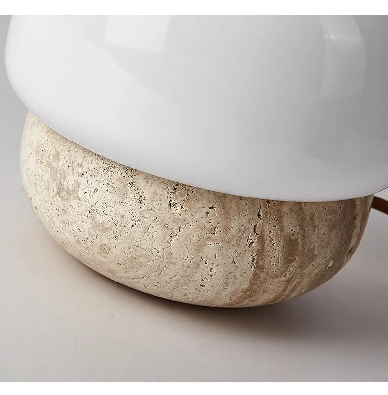 Cream-coloured retro style bedside lamp on a table.