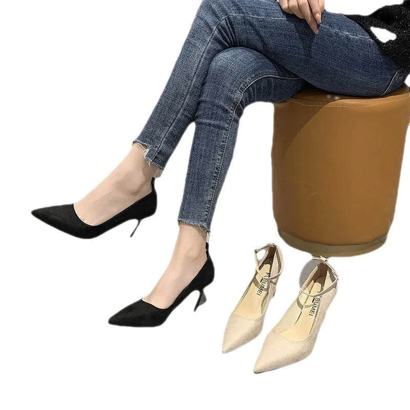 Women's black stiletto heel pump shoes with skull pattern and buckle detail on a white background