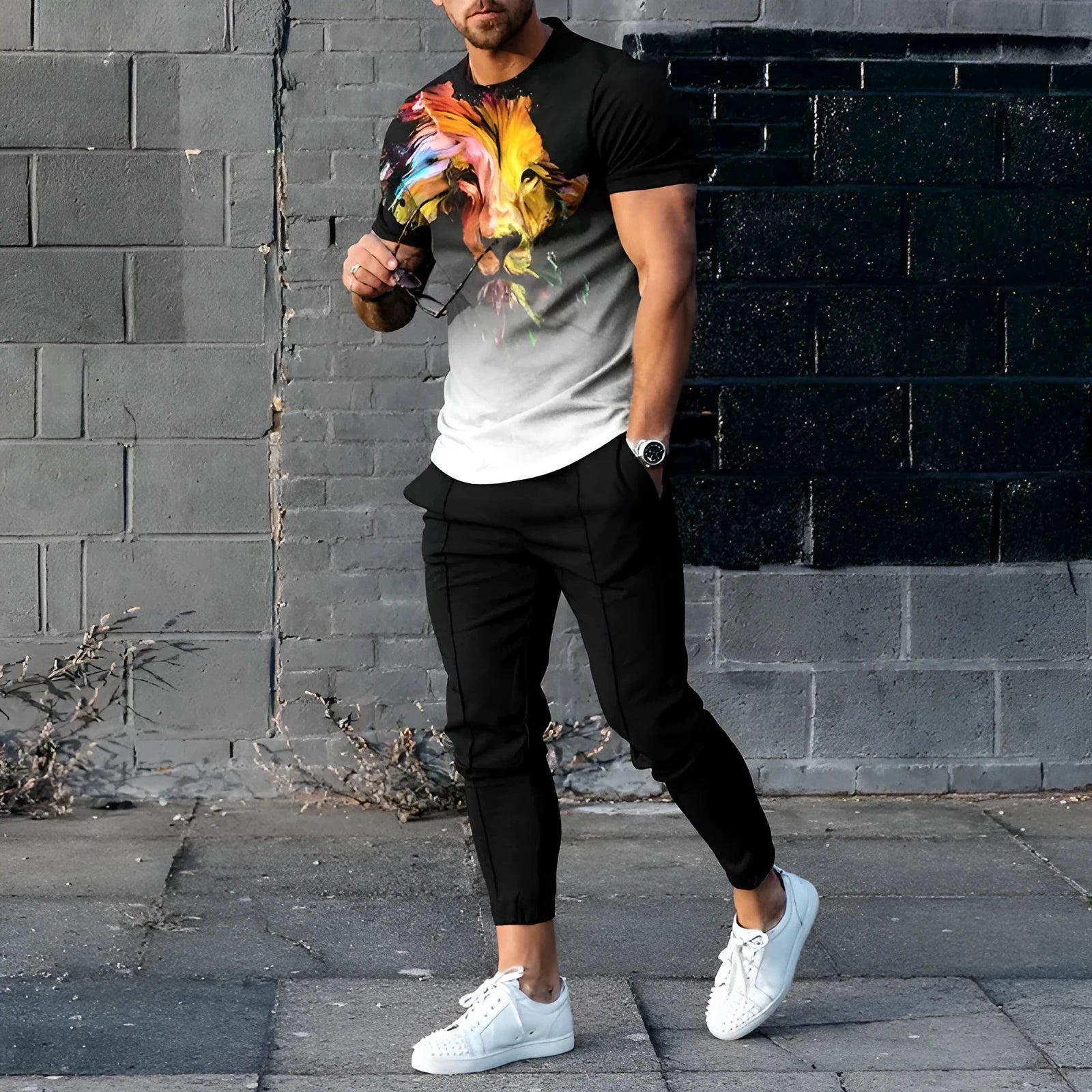 Man wearing a short-sleeved printed pullover and matching trousers from a polyester sport suit set.