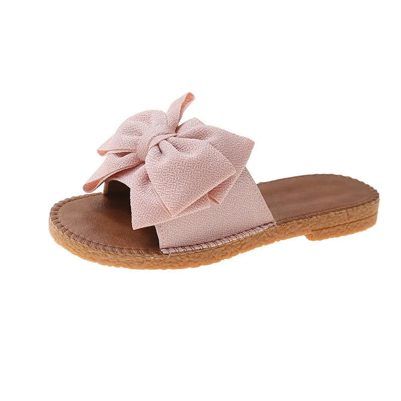 Women's slip-on suede sandals with bow detail, flat heel, rubber sole – beige colour option