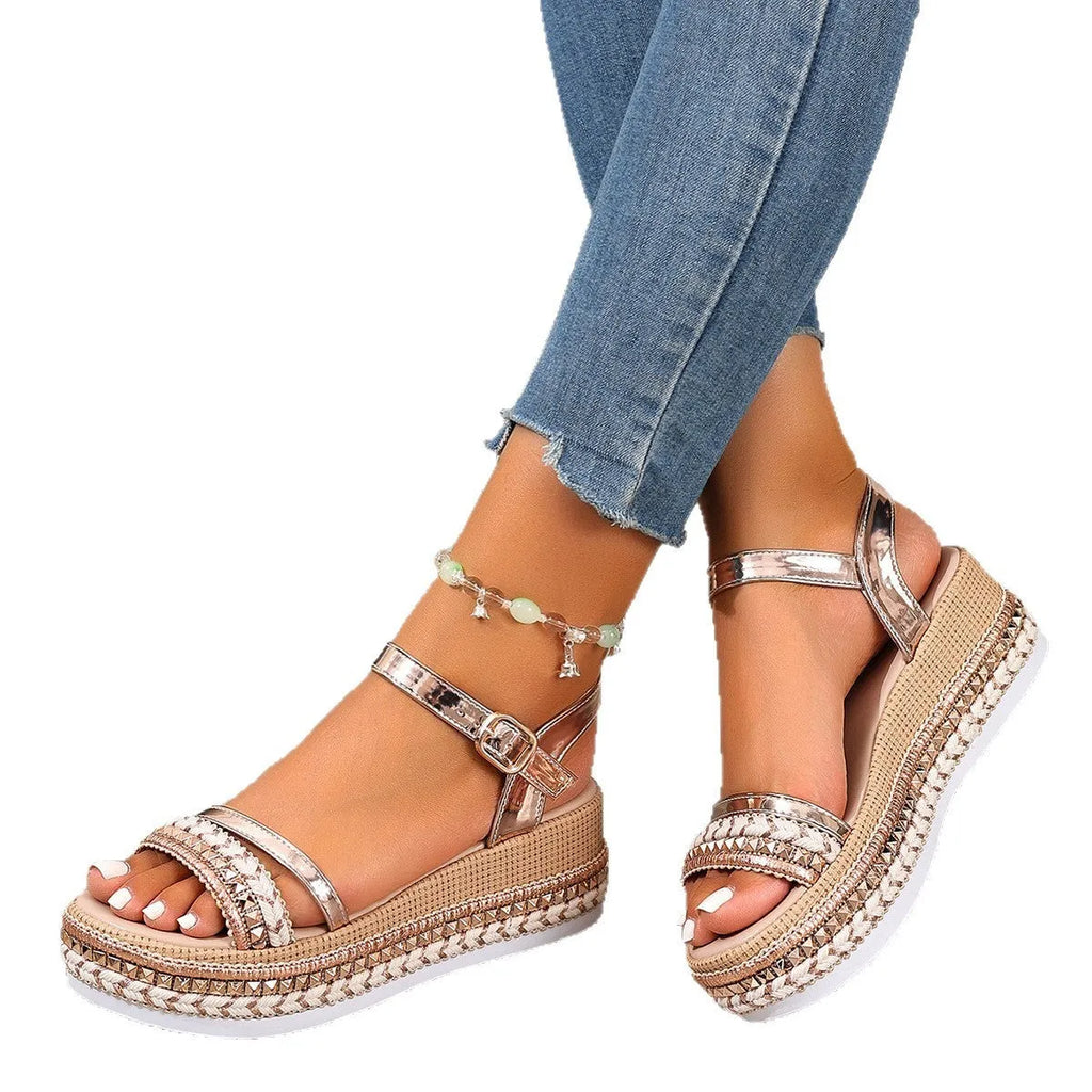 Women's woven wedge sandals in gold with round toe and PU upper, side view on neutral background