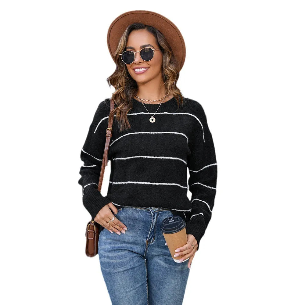 Women's loose-fitting striped pullover sweater with a round neck, shown in black and white colour options.