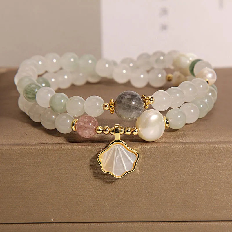 Women's crystal bracelet with green ginkgo leaf pendant, gold accents and rhinestones