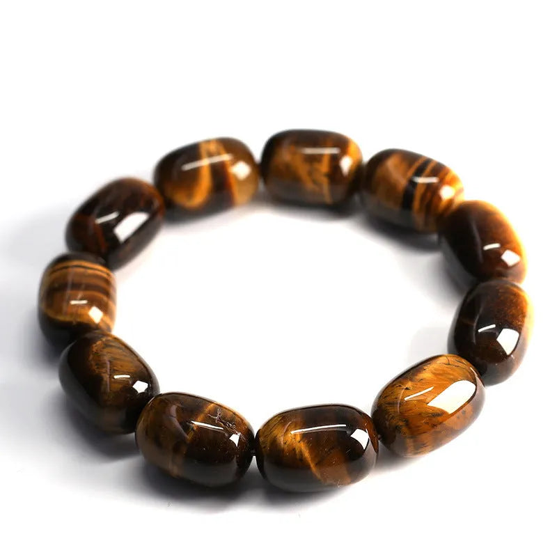 Natural yellow tigereye bracelet with sunny cat eye effect, ball beads in 11x16mm size on light background