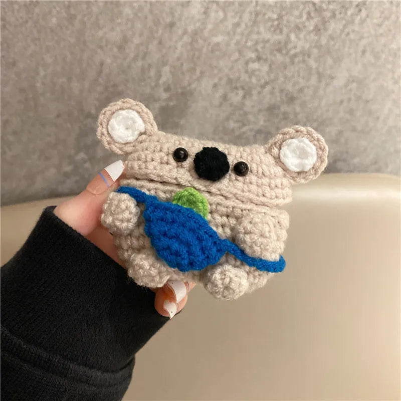 Hand-knitted koala bear backpack design cover for Apple AirPods charging case on a white background.