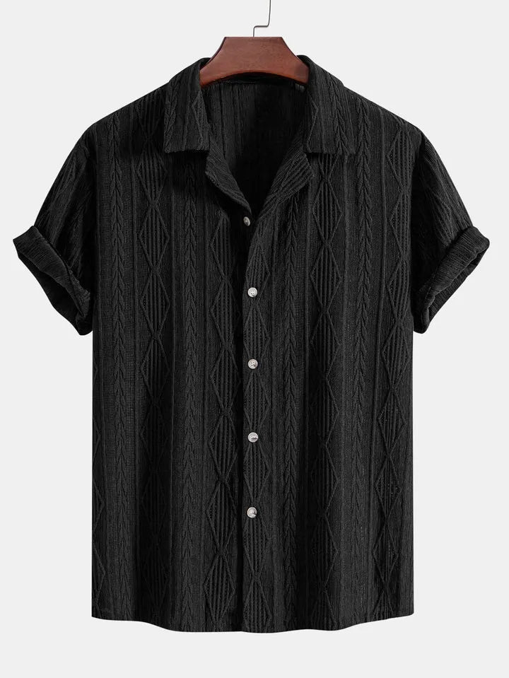 A man wearing a loose-fit black short-sleeve cardigan shirt for casual summer wear.
