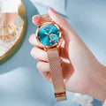 Women's fashion watch with a metal mesh strap, rose shell caseback, and a choice of six coloured dials.