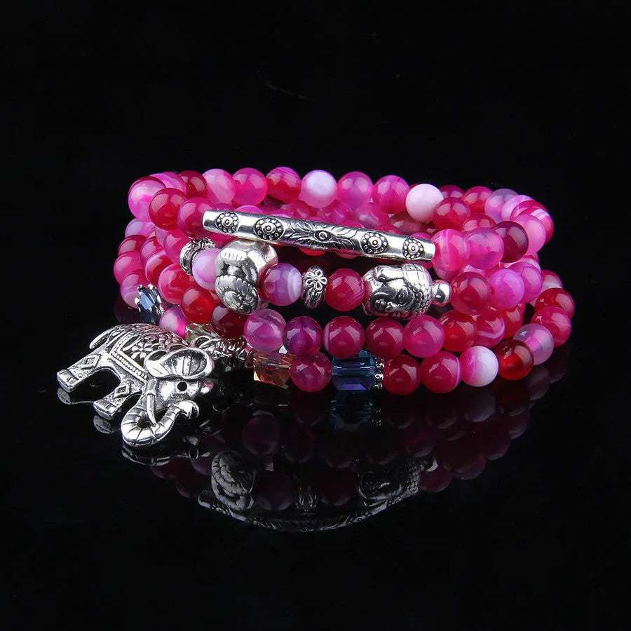 Multi-layer natural agate bracelet with 6mm beads in blue elephant pattern on a neutral background