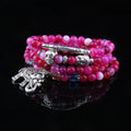 Multi-layer natural agate bracelet with 6mm beads in blue elephant pattern on a neutral background