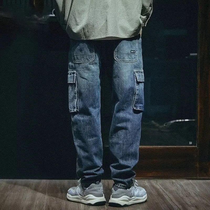 Man wearing blue loose straight-leg denim jeans with a zip fly, casual style.