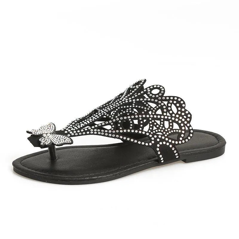 Gold women's slip-on sandals with rhinestone detail on the flip-toe strap and a flat rubber sole.