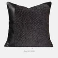 Grey and white plaid bed runner blanket with leather round pillow on bed