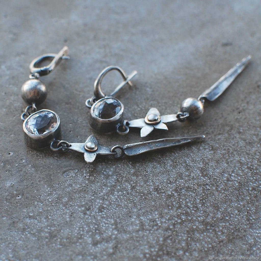 Geometric XINGX pendant earrings with antique silver plating and rhinestone details