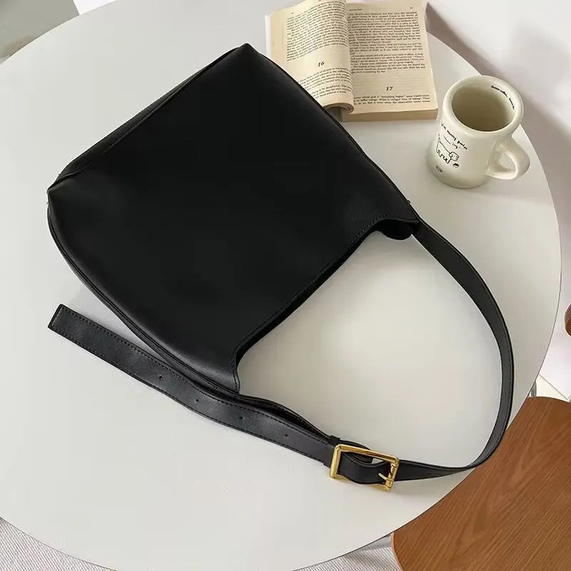 Women's black PU leather shoulder bag with swing thread design and adjustable strap