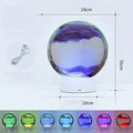 Creative 3D quicksand table lamp with glass shade on bedside table showing blue light colour