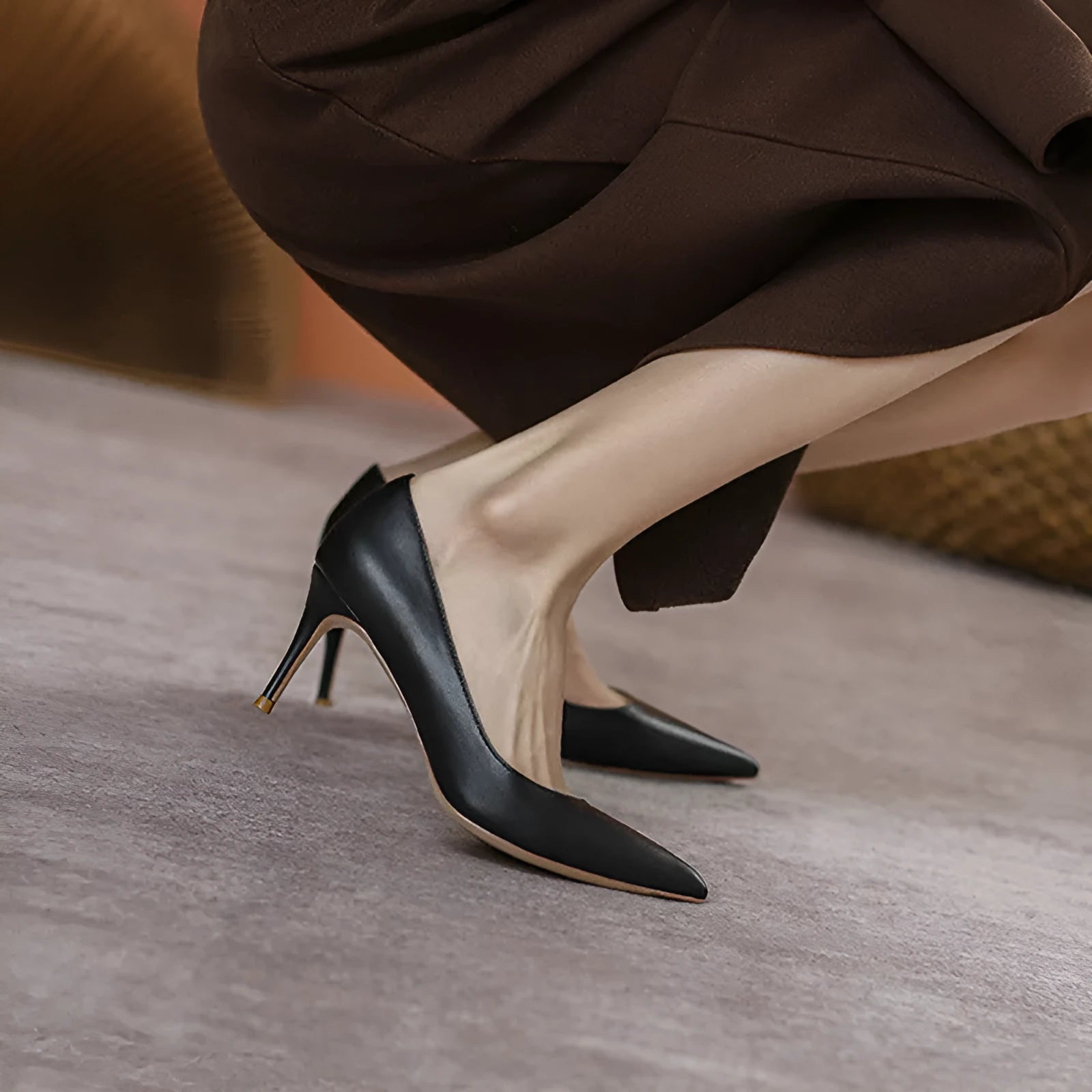 Black pointed high heel shoes with stiletto heel and microfiber upper on a white background