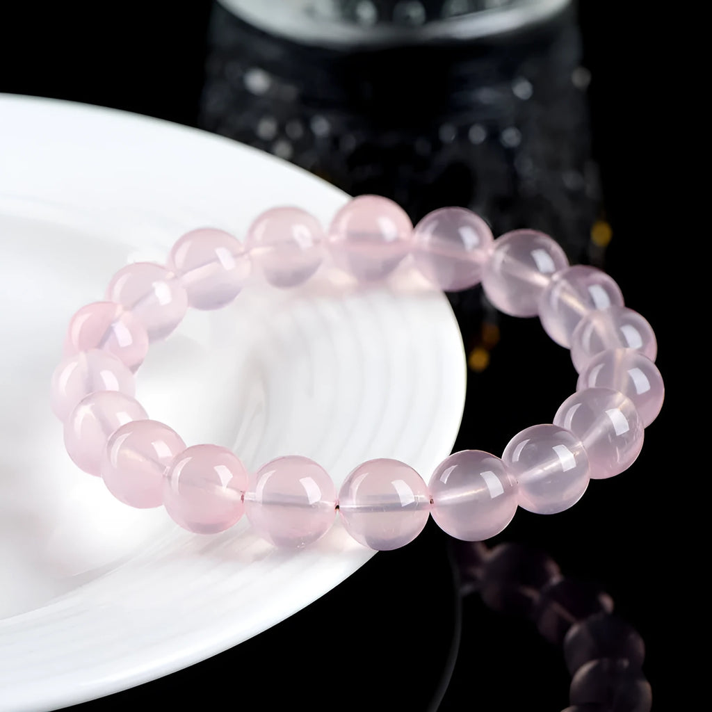 Natural starlight crystal round bead bracelet in pink with polished finish showing bead detail