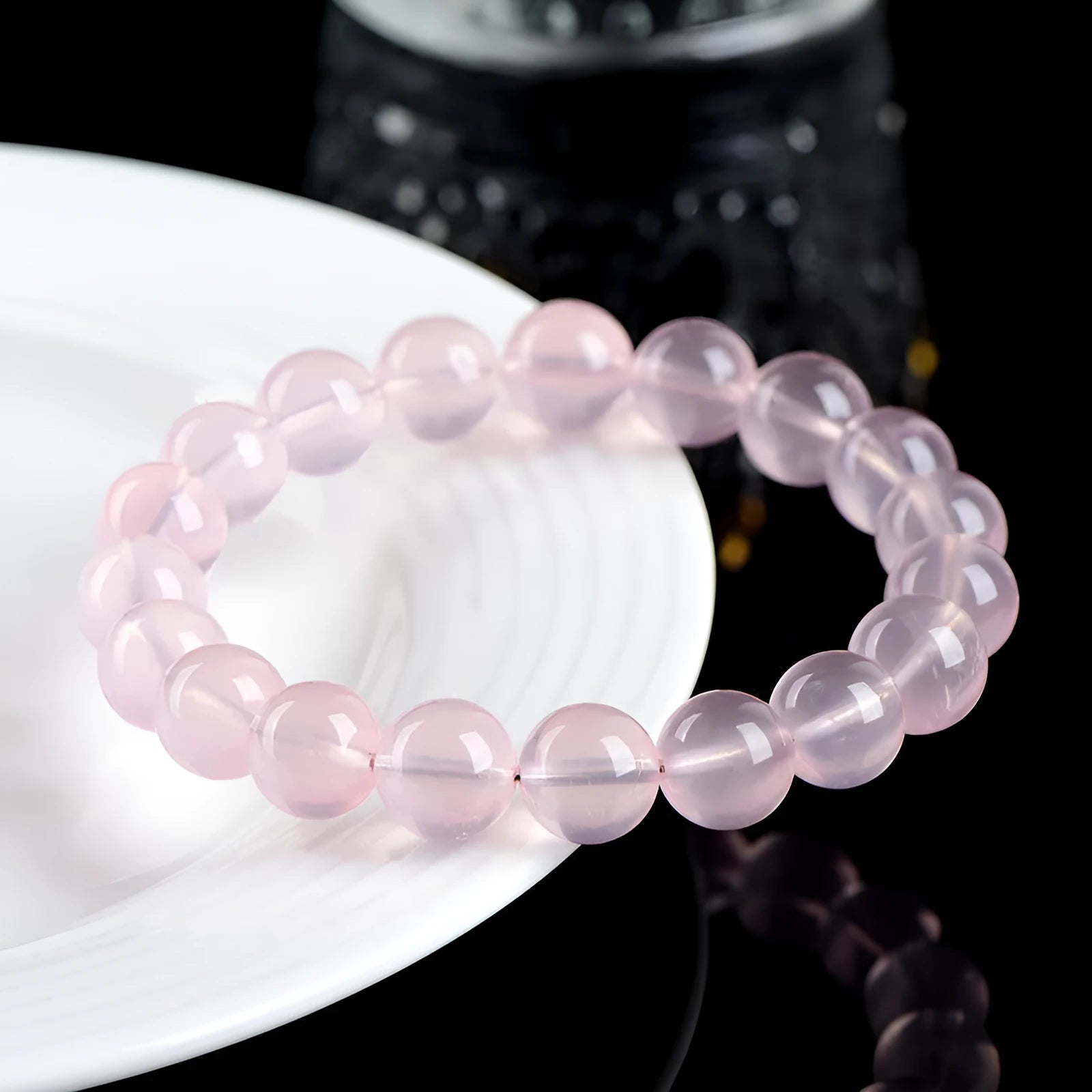 Natural starlight crystal round bead bracelet in pink with polished finish showing bead detail