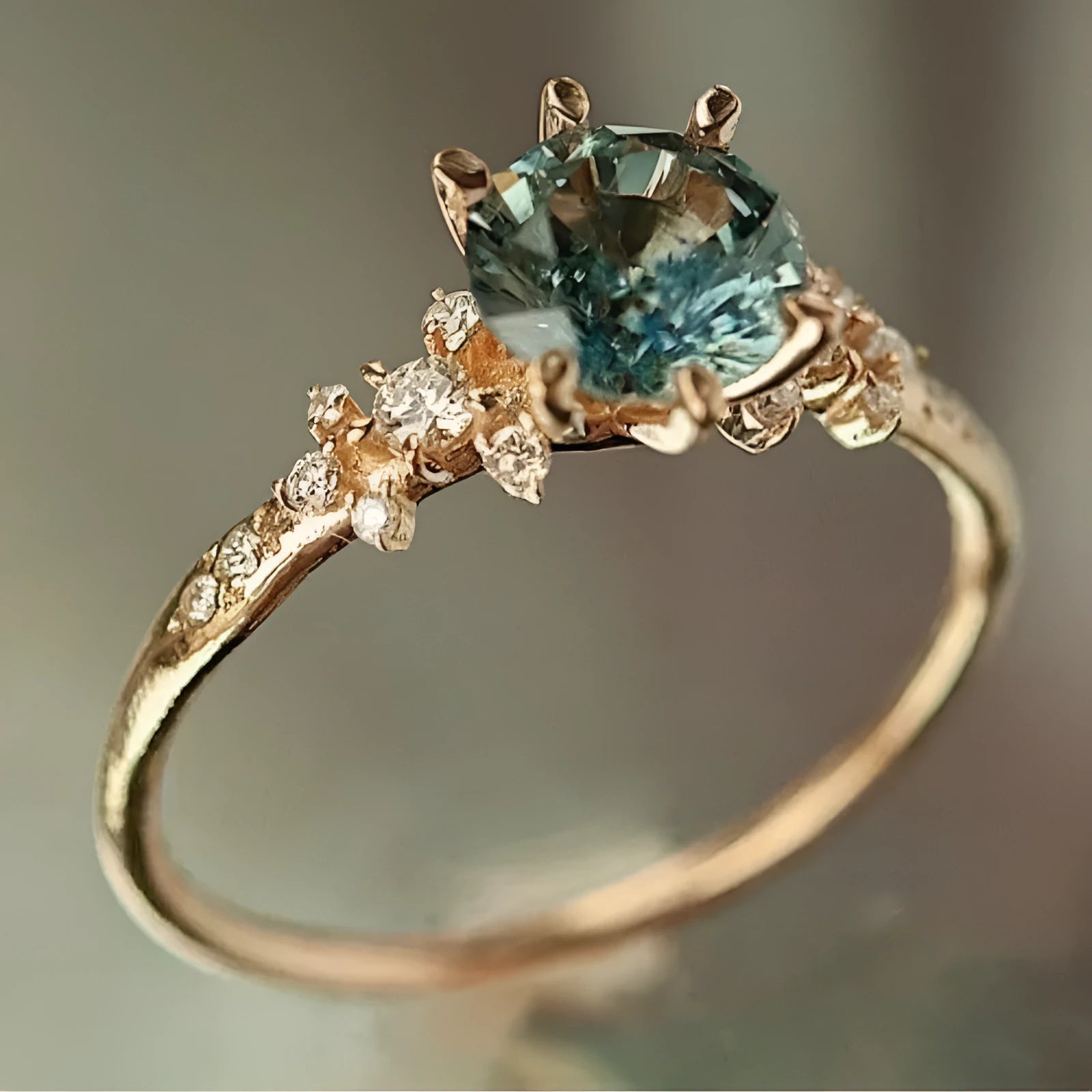 Geometric gold claw ring with inlaid zircon stones showing chamfered square pattern