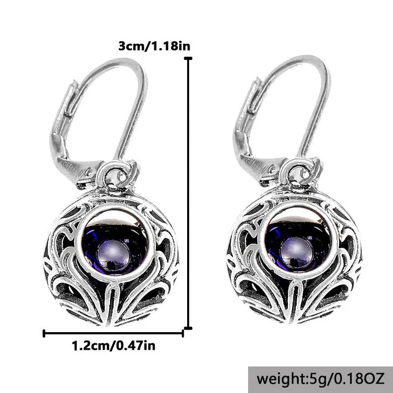 Vintage silver hollow pendant earrings with blue gemstone accent on geometric drop shape